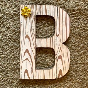 Letter B wall decor. In great condition. Has small yellow flower top left.